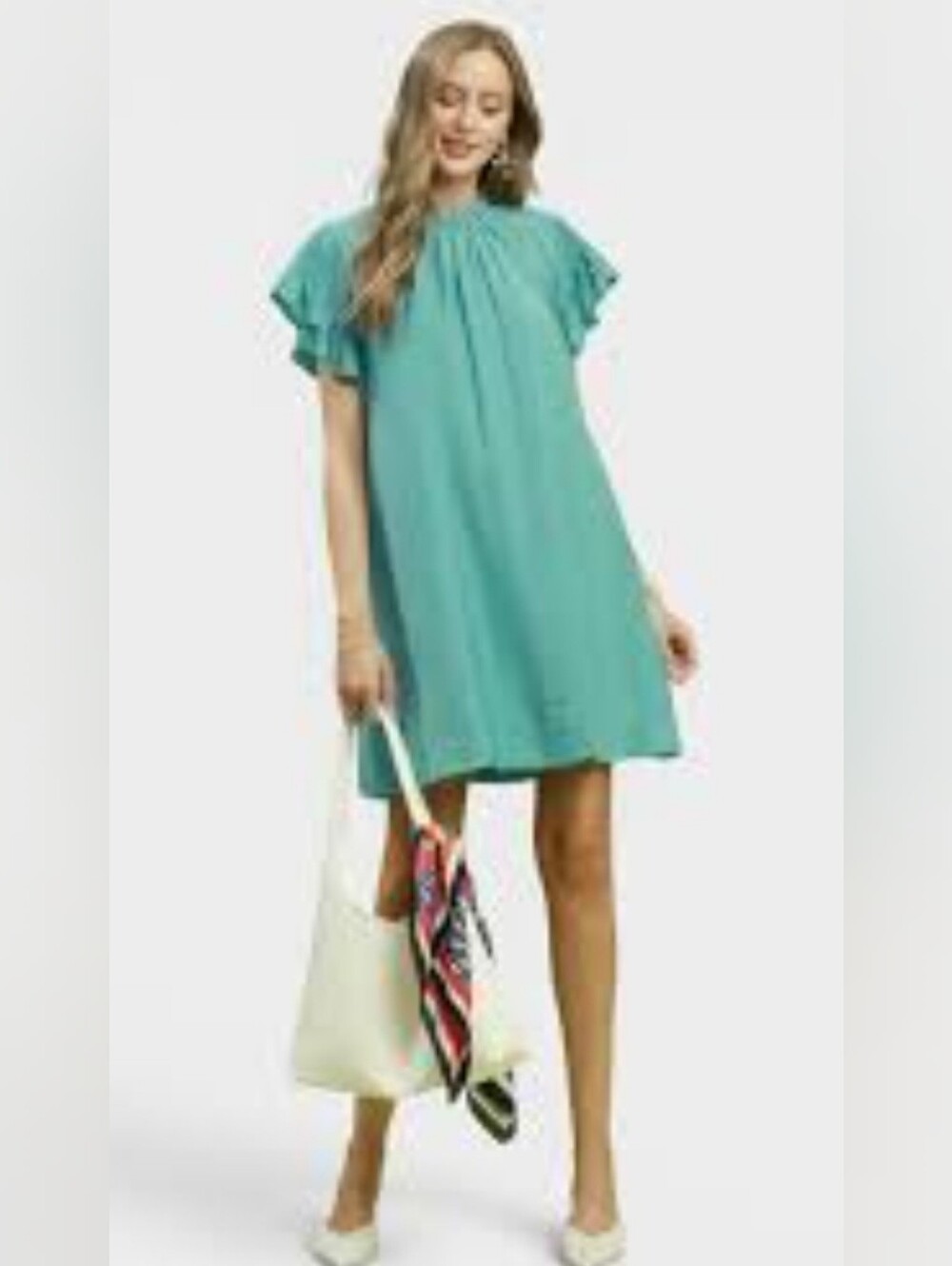 Umgee dress features a relaxed, shift-style silhouette in a solid teal green hue